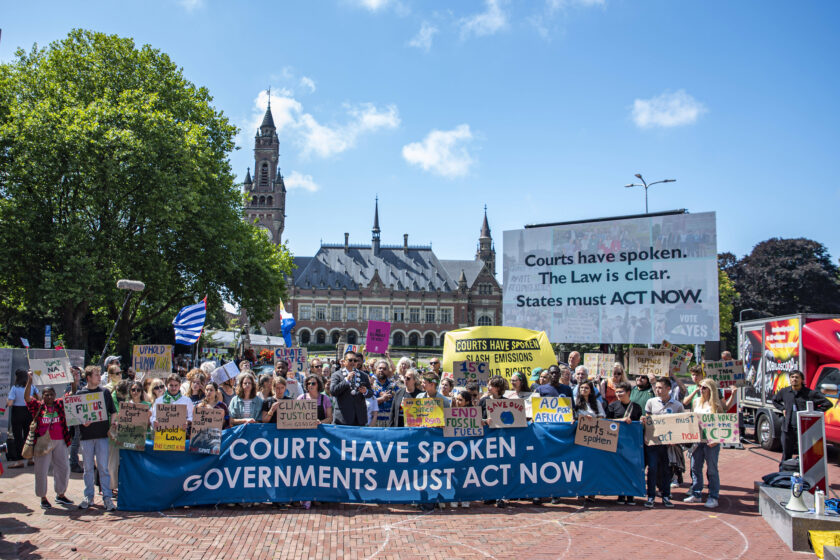 Climate and human rights activists demonstrate before the International Court of Justice.