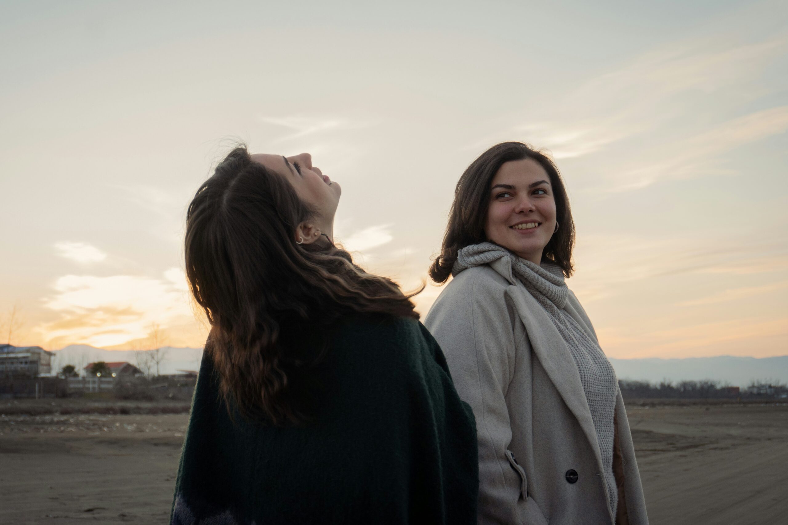 Zwei junge Frauen stehen draußen auf einem Feld
